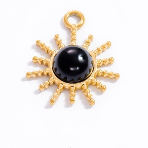 Macro shot of 18k gold plated sun pendant with natural black obsidian inlay