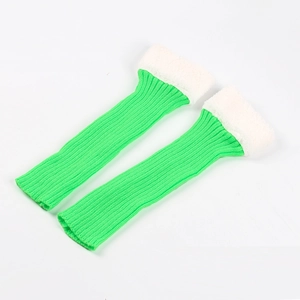 Detail of bright green knit leg warmers with soft white faux fur trim on top cuffs