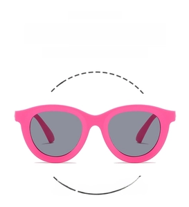 Detail of pink flexible resin frame and dark grey UV lenses on kids sunglasses