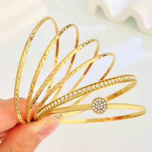7-piece gold bracelet set featuring diamond textures and sparkling zircon accents