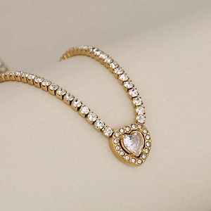 Elegant gold heart pendant tennis necklace with shimmering white crystal stones for women