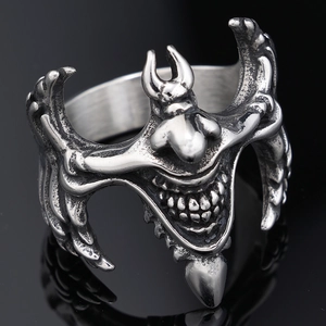 Detailed close-up of gothic stainless steel clown ring with intricate bat wing design