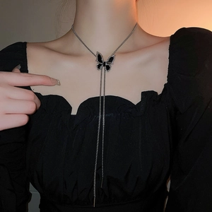 Elegant butterfly pendant Y-necklace with silver chain and rhinestones on a model