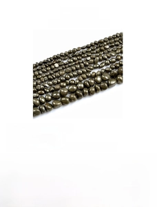 Detail view of irregular natural pyrite stone beads with metallic luster for jewelry making