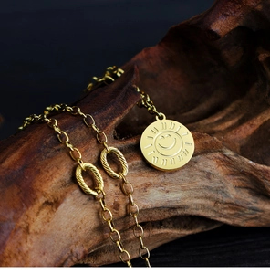 Detail of a golden sunflower smiley face pendant on a textured dark wood background