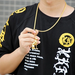 Close-up of a 18K gold-plated Egyptian Bastet cat goddess pendant worn by a male model