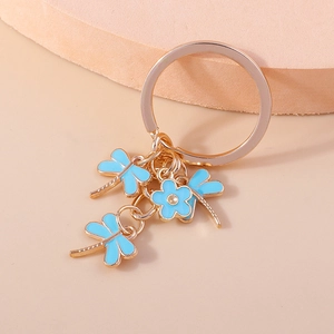 Creative keychain featuring gold metal ring with light blue dragonflies and flower charms