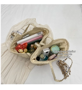 Spacious interior of beige woven straw tote bag filled with daily essentials