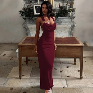Detail of burgundy backless dress with ruched details and lace-up ties in a room