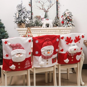 Detail of Christmas chair covers featuring 3D Santa and snowman motifs in red knit fabric