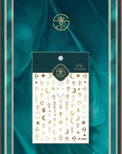 Detailed view of M-055 gold foil nail stickers featuring sun and moon celestial motifs
