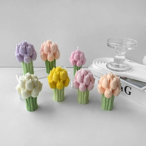 Detail of colorful tulip bouquet candles on clear acrylic stands with white backdrop