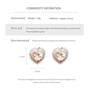 Macro shot of silver needle heart stud earrings with copper and cubic zirconia detail