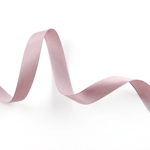 Detailed macro view of the smooth, glossy surface of a soft purple-pink satin ribbon