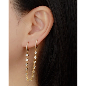 Close-up of gold S925 sterling silver tassel earrings with dangling crystal chains