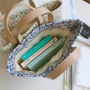 Detail of floral tote bags with leather handles and zip closure for daily essentials
