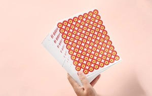 Close-up of cute red flower star stickers on a sheet for student rewards and school use