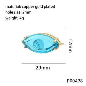 Macro view of gold-plated copper evil eye charm with blue crystal and size details