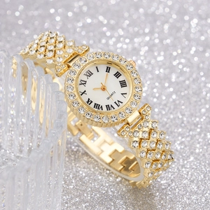 Close-up of golden Roman dial watch with luxury crystal rhinestone bezel and strap details