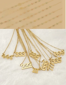 Macro detail of gold 18K plated stainless steel lucky number pendant on a soft texture
