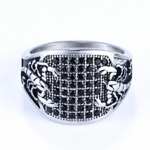 Macro shot of vintage steel ring featuring black zircon stones and scorpion engraving