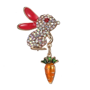 Cute golden rabbit brooch with colorful rhinestones and carrot pendant on white background