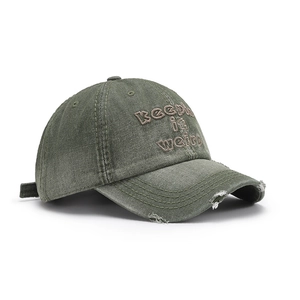 Vintage washed olive cotton baseball cap with Keep it weird embroidery and distressed brim