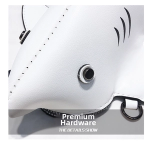 Detailed macro view of white pebble leather shark bag with black metal eyelets