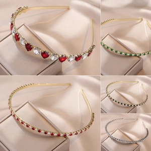 Cross-shaped zircon headband with emerald green stones and red heart diamond accents
