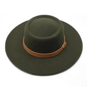 Detail of dark green flat top wool felt fedora with brown leather band and gold metal studs