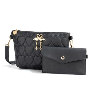 Women's black quilted crossbody bag set with heart pattern and golden swan hardware