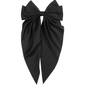 Detail of elegant black satin bow hair clip with long ribbons and smooth texture