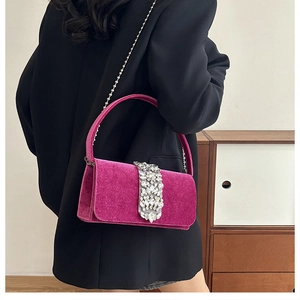 Detail of fuchsia velvet evening bag with sparkling rhinestone crystal embellishments