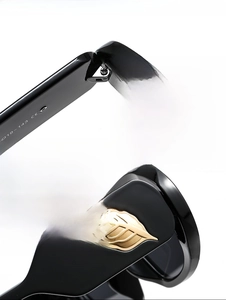Detail of golden leaf hinge and black frame on stylish oval sunglasses with CE mark