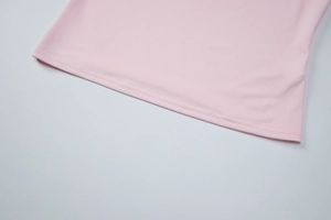 Close-up of pink tank top hem with professional double-needle stitching and smooth fabric