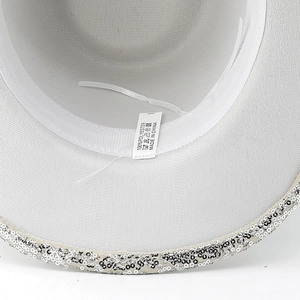Detail view of white sequins cowboy hat with 100% polyester fabric and manufacturing label