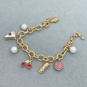 Golden link bracelet featuring cherry and pastry charms with zircon and pearl accents