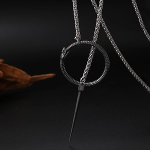 Detailed view of snake ring pendant with sharp spike on a woven silver chain