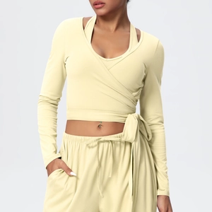 Detail of cross wrap long sleeve top with side bow tie in soft cream yellow fabric