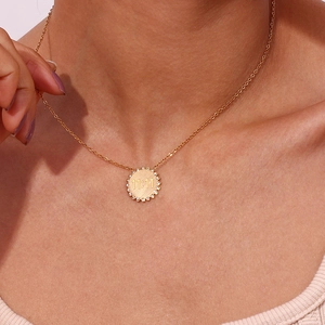 Detailed view of 18K gold-plated sun flower pendant necklace with 11:11 engraving and crystals