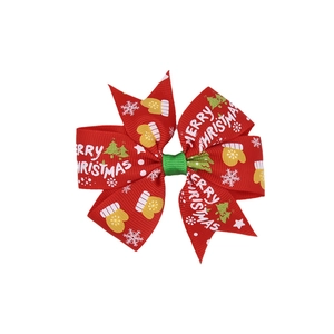 Close-up of Christmas hair bow with Merry Christmas print and festive icons