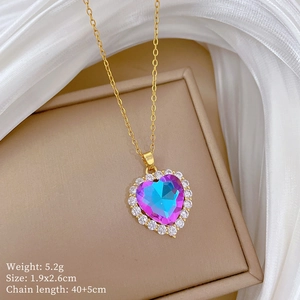 Detail of gold heart necklace with purple gradient stone and zircon on silk