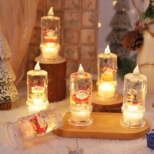 Detail of light-up Christmas water candles with Santa and snowman figurines inside