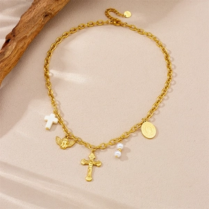 Detailed view of vintage gold plated necklace with cross, angel and pearl charms
