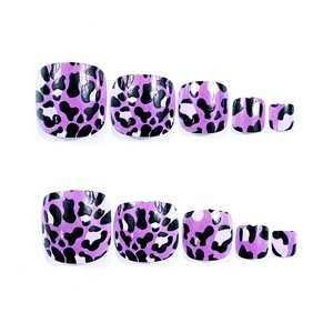 Close-up of glossy purple leopard print press-on toenails on white background