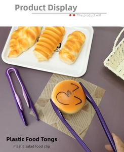 Detailed close-up of purple plastic food tongs picking up fresh bread for serving
