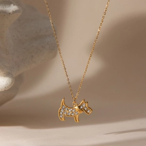 Close-up of golden dog pendant necklace featuring sparkling pavé zircon stones