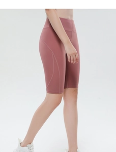 Detail view of high waisted yoga shorts in dusty rose with curved seams for contouring