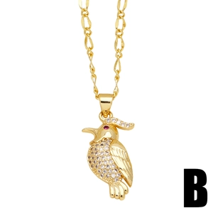 Elegant gold bird pendant necklace with white and red crystals on a white background