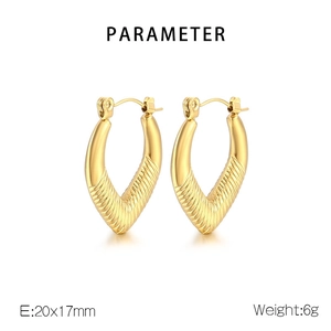 Detail showing the 20x17mm gold heart-shaped hoop earrings with textured striped finish